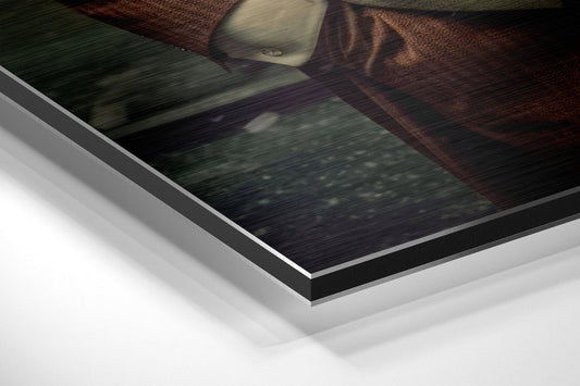 Close-up angled view of layered Dibond wall art showing white backing, black edge trim, and brushed aluminum surface with textured fabric detail visible.