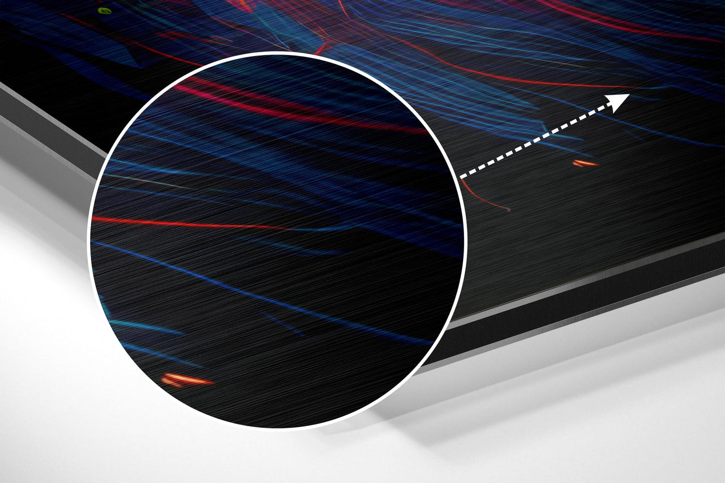 Close-up angled view of brushed aluminum wall art showing blue and red light streaks with white circular frame and directional arrow on dark textured surface.