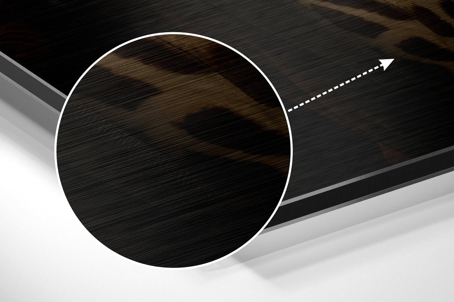 Close-up angled view of brushed aluminum circular disc with white border and directional arrow, showing metallic surface texture and shadow detail.