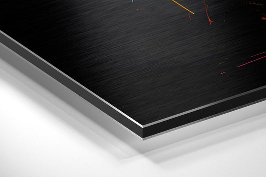 Close-up angled view of layered aluminum dibond panel edge showing black brushed surface with colored wire details and gray backing layers.
