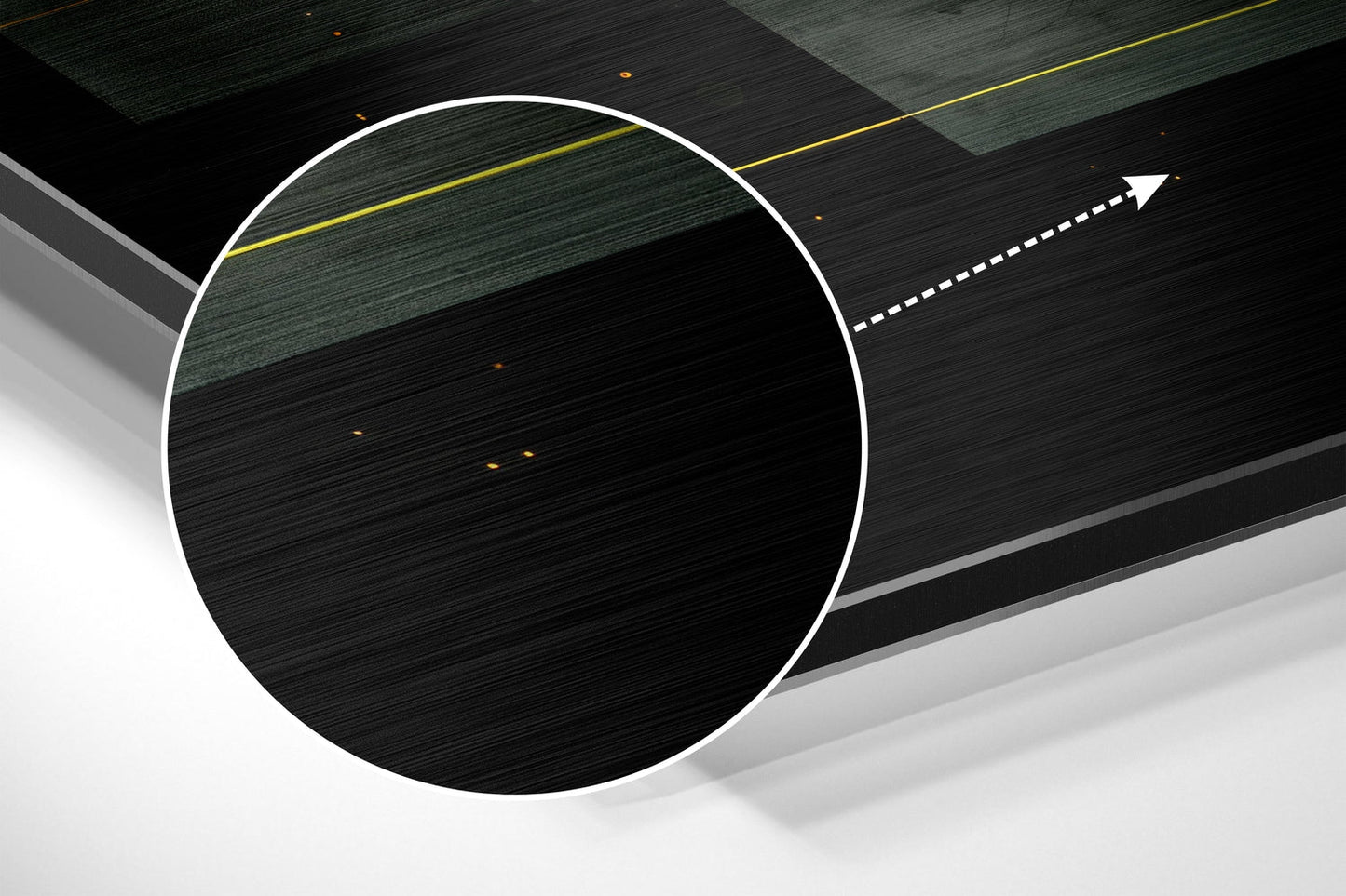 Angled three-dimensional view of brushed aluminum wall art featuring a white-outlined circle, yellow and dashed white lines, against dark textured background panels.