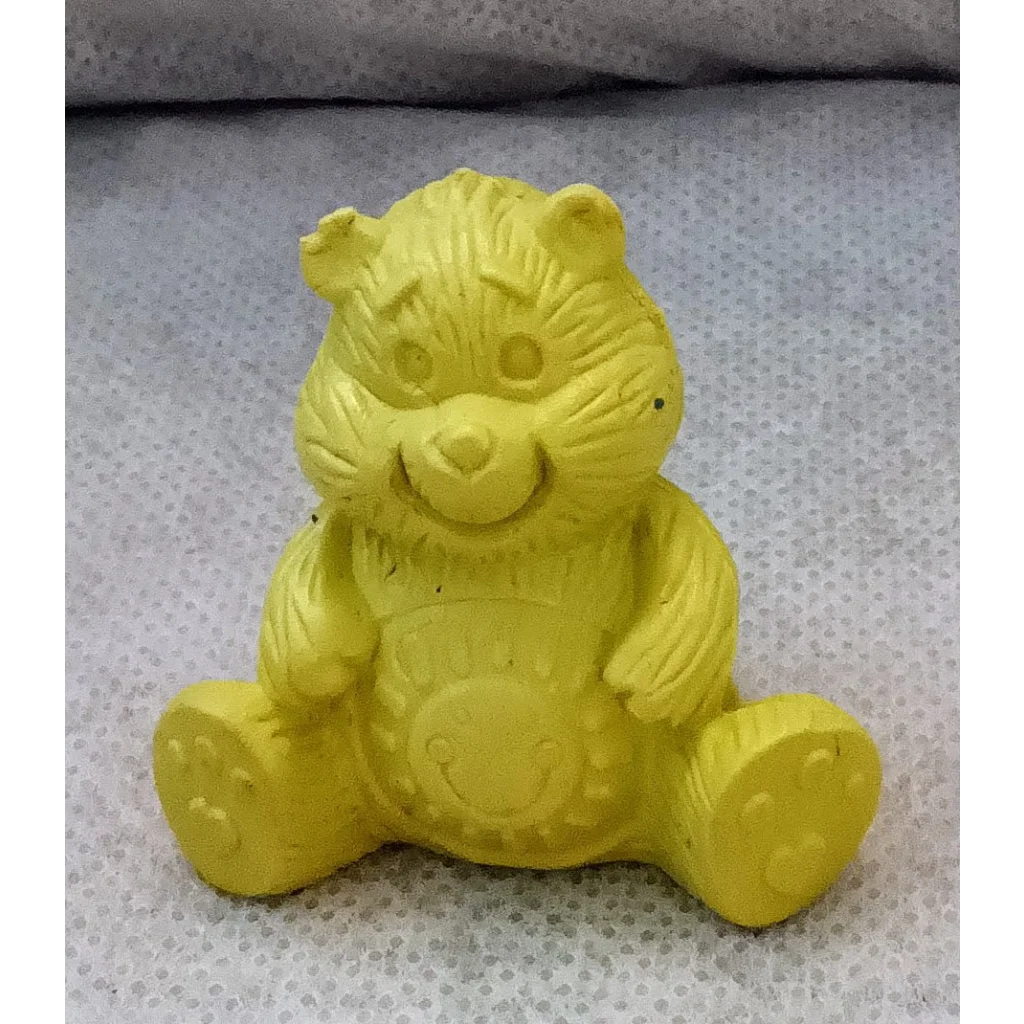 Adorable yellow Care Bears pencil topper with paw print feet