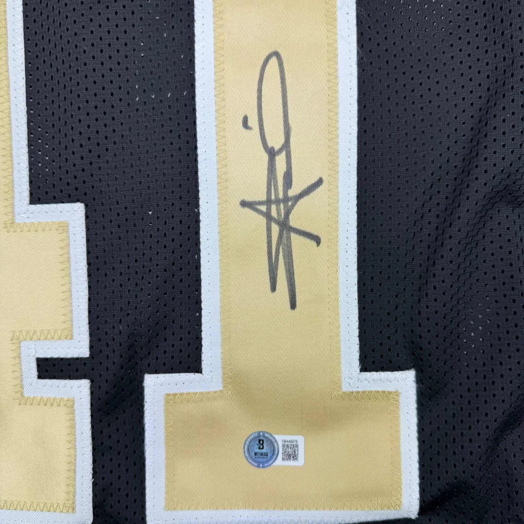 Autographed black and gold Alvin Kamara Saints jersey perfect for your man cave