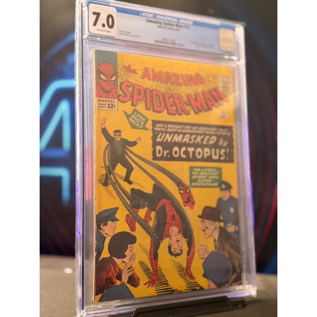 A vibrant yellow comic book cover of Amazing Spider-Man 12 5/64 featuring Spider-Man in red and blue suit in protective grading