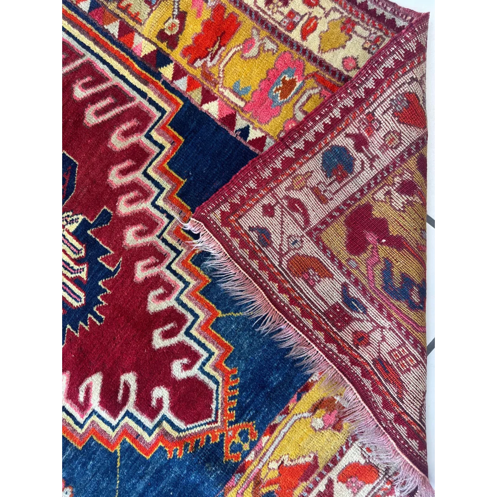 Vibrant antique Turkish Melas rug with geometric floral patterns