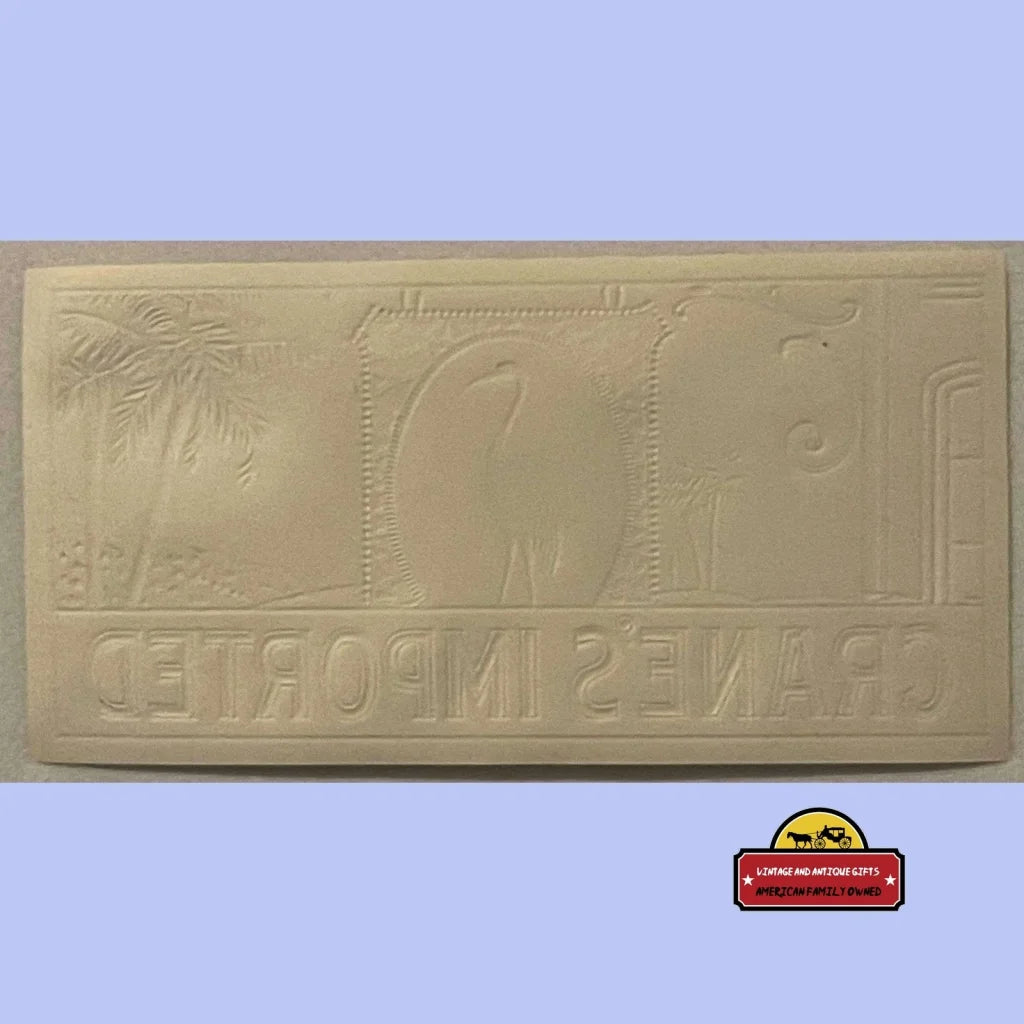 Rectangular rubber stamp featuring a rare embossed cigar label with Egyptian art