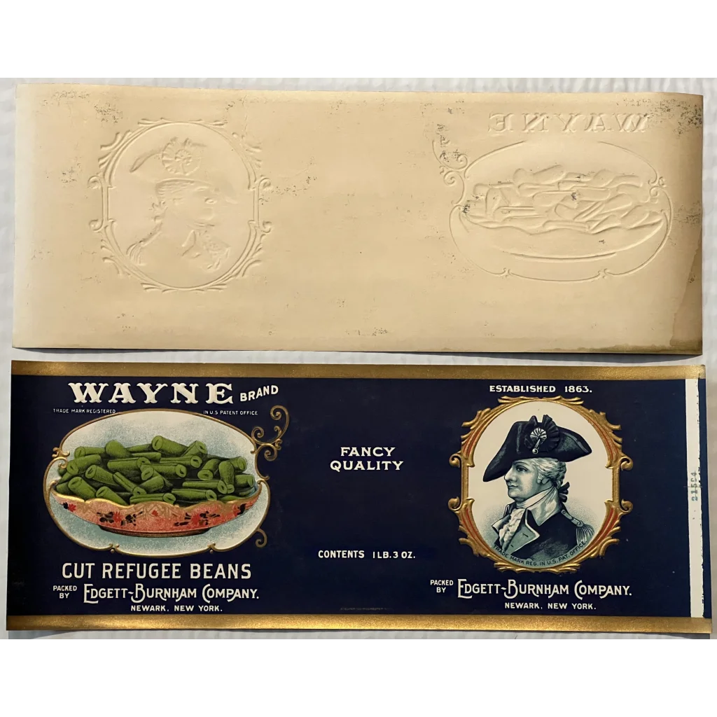 Vintage Wayne Gold embossed can label with a colonial figure showcasing cut refugee beans