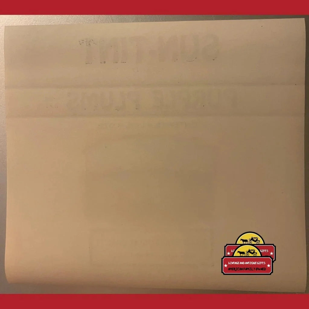 Manila envelope showcasing a Rare 1930s Sun-Tint Plum Label with a fun cartoon sticker