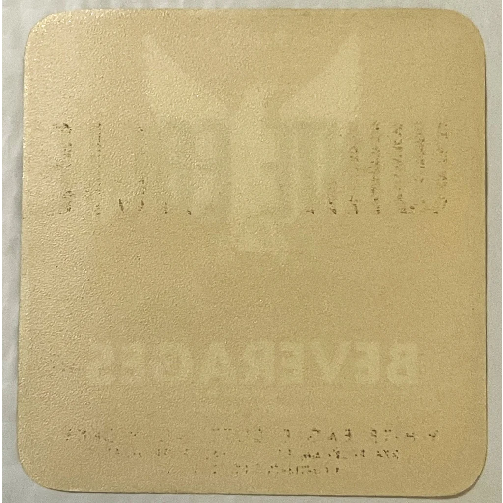 Pale yellow square coaster with gold embossed design for antique vintage beverage label