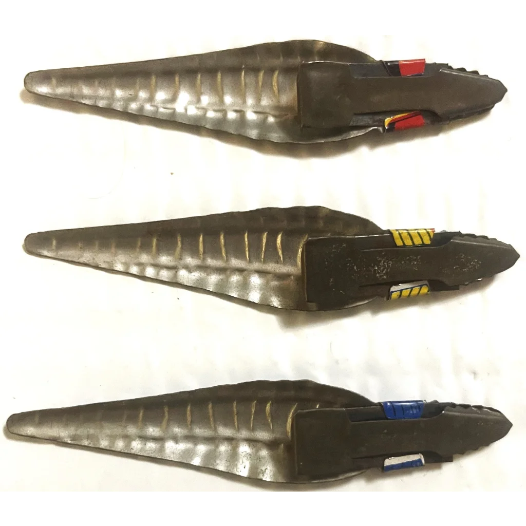 Three futuristic handheld devices with metallic designs in Antique Vintage 1950s style