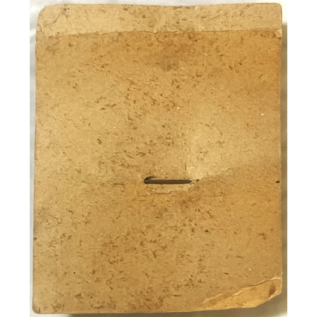 Weathered tan book cover with a slit, perfect for 1950s tin special badge history