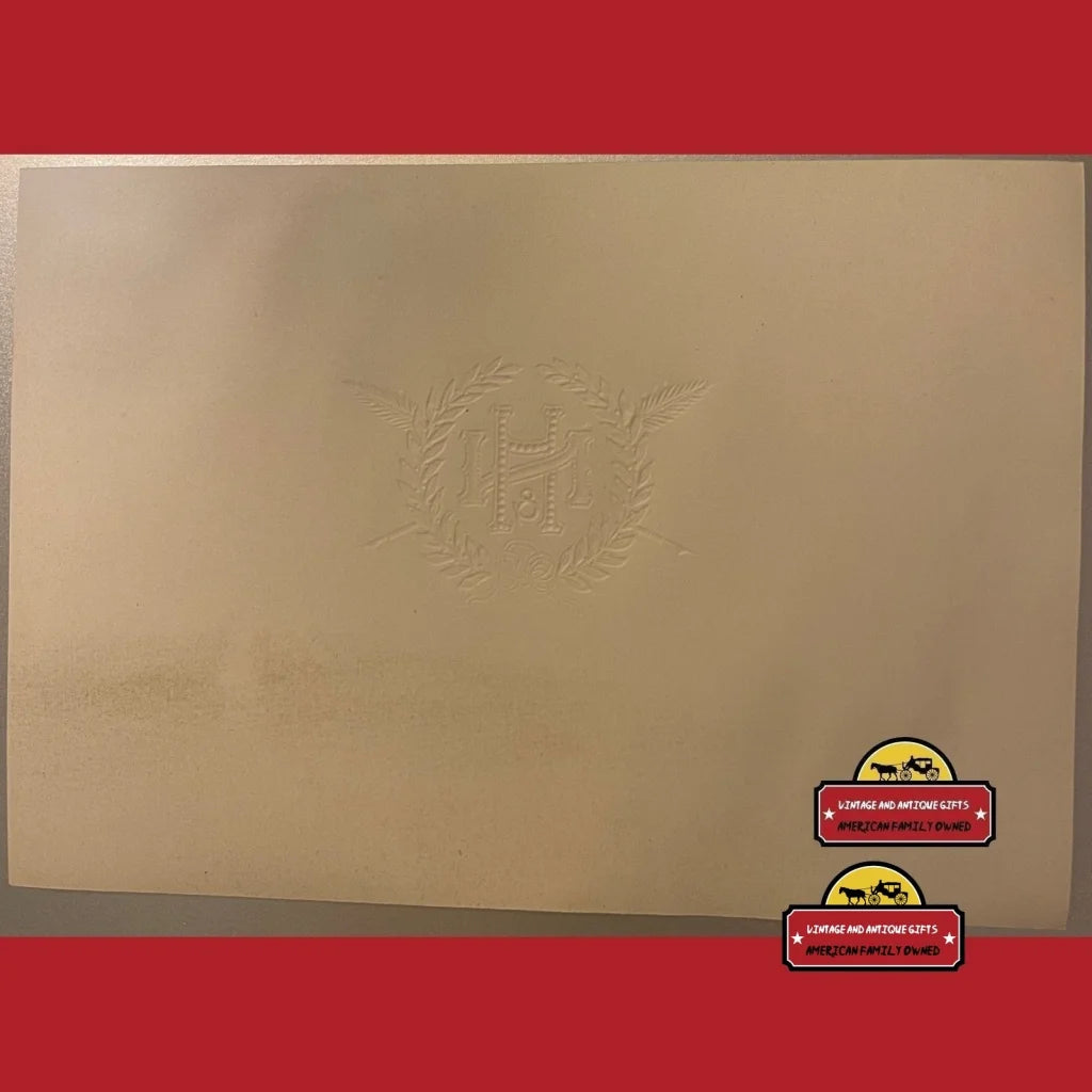 Gold laptop with embossed logo and red stickers, echoing Rare Embossed Cigar Label style