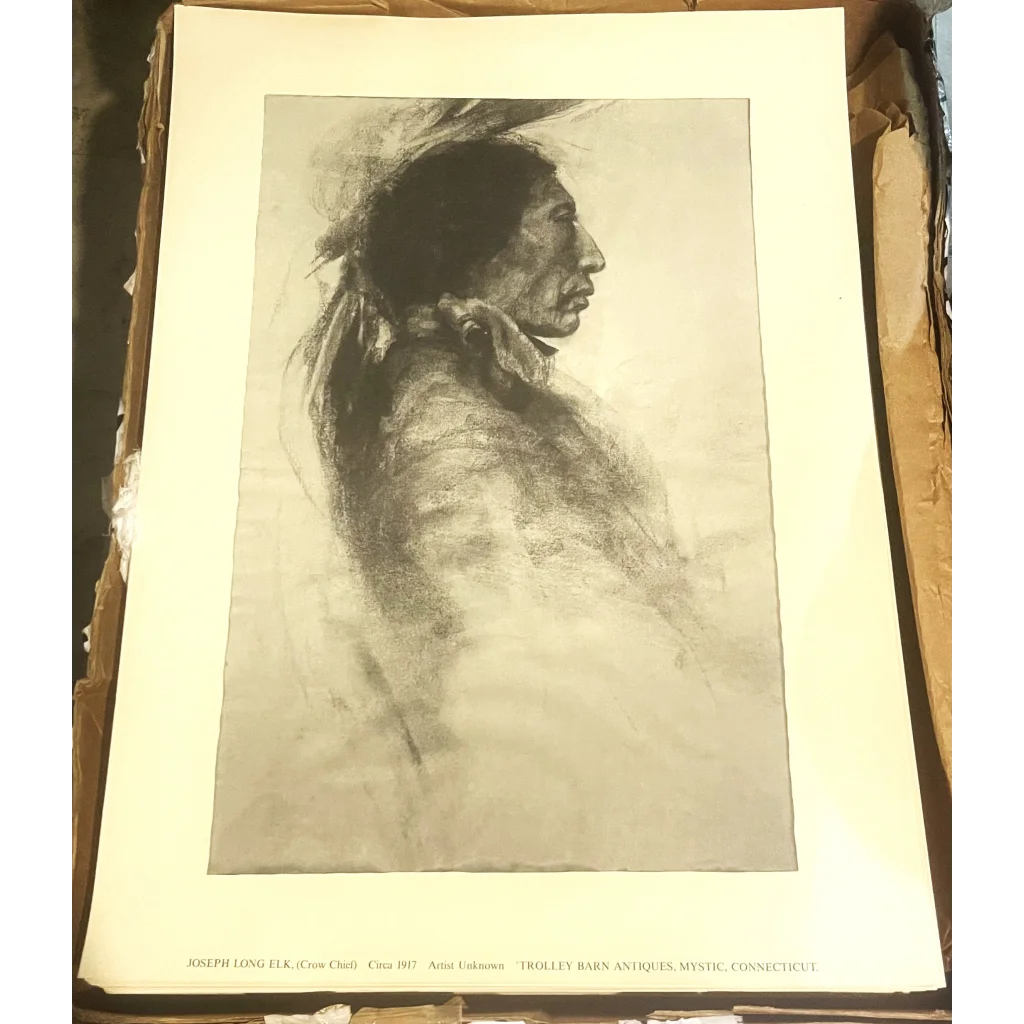 Black and white portrait of a Native American man in feathered headdress at Trolley Barn