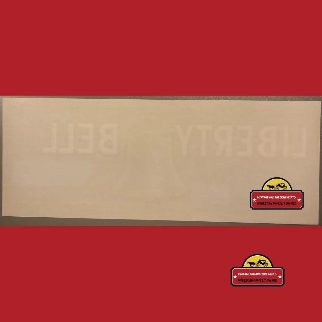 Cork board with wooden frame on red wall, perfect for Antique Liberty Bell crate label display