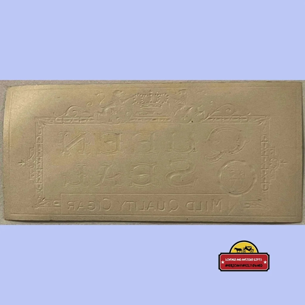 Golden rectangular plaque with embossed numbers on a Rare Antique Queen Seal Cigar Label