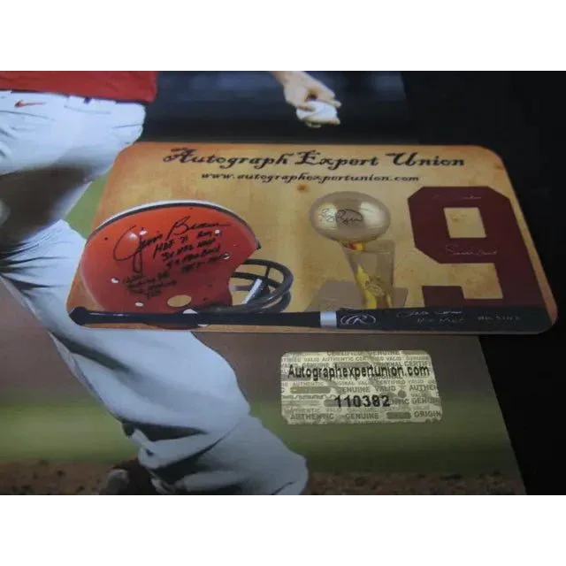 Autographed football helmet, bat, trophy with 8x10 photo of Aaron Nola on display