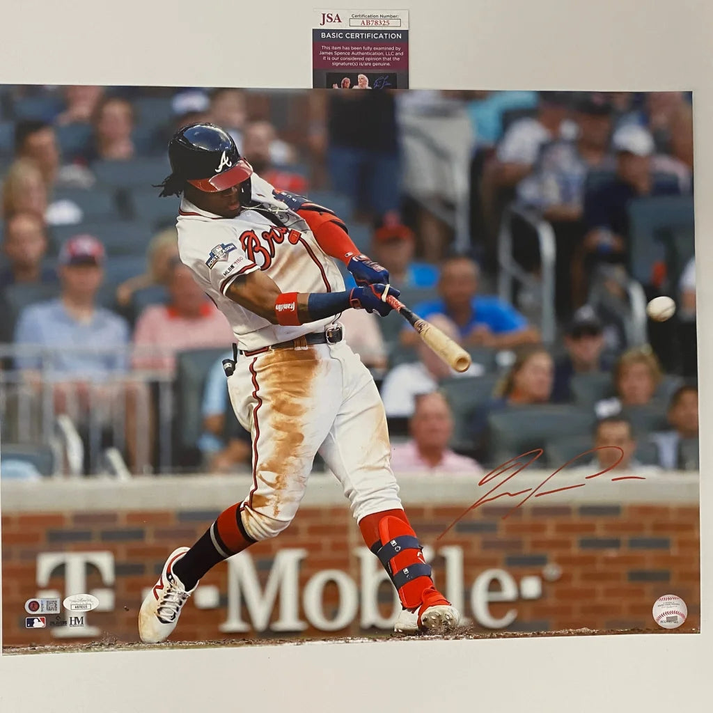 Autographed baseball action photo of player hitting ball with certification