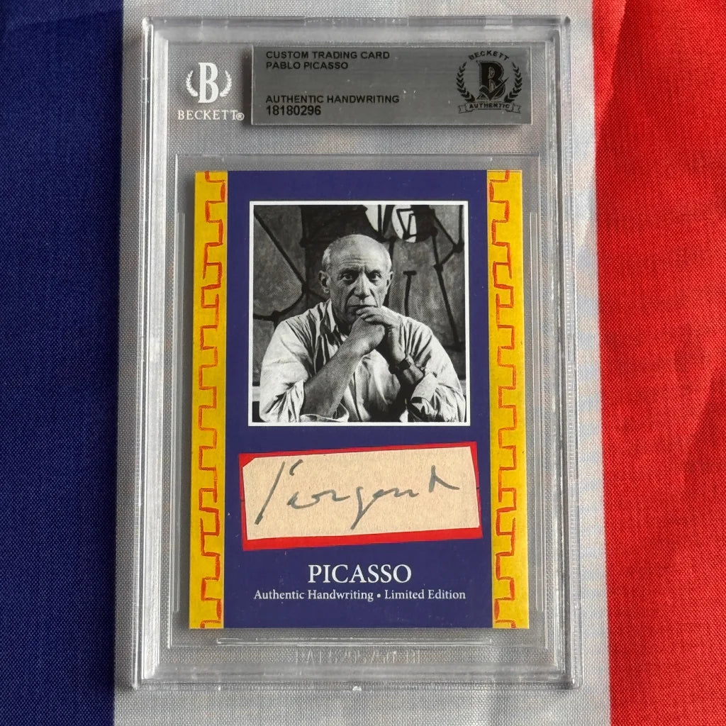 A framed authentic pablo picasso handwriting trading card with black and white portrait and beckett authentication holder