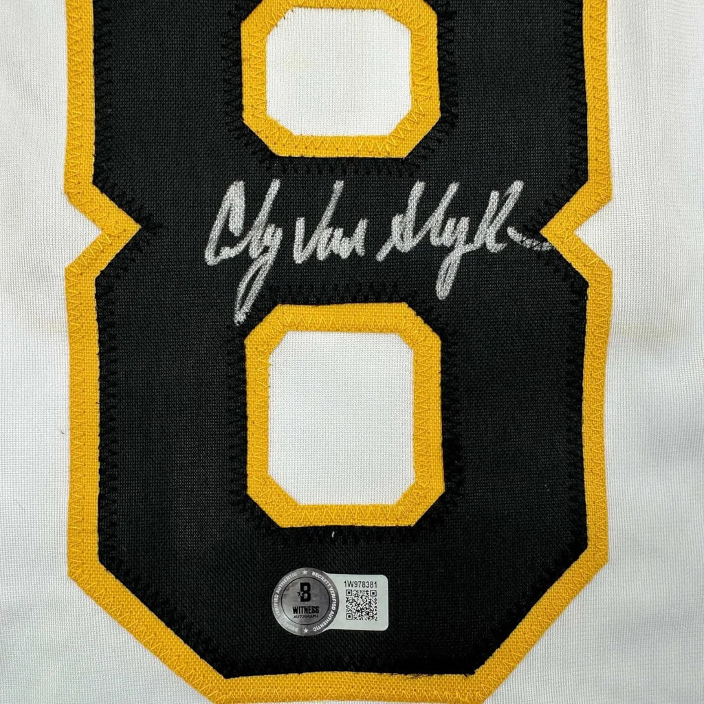 Autographed black and gold hockey jersey with number 8, in display