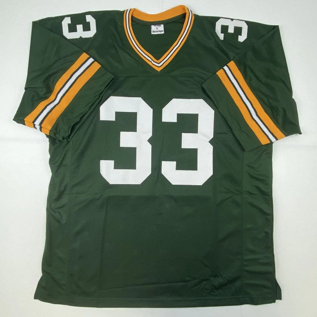 Autographed aaron jones green bay custom jersey in green with white number 33 and orange trim from professional sports league