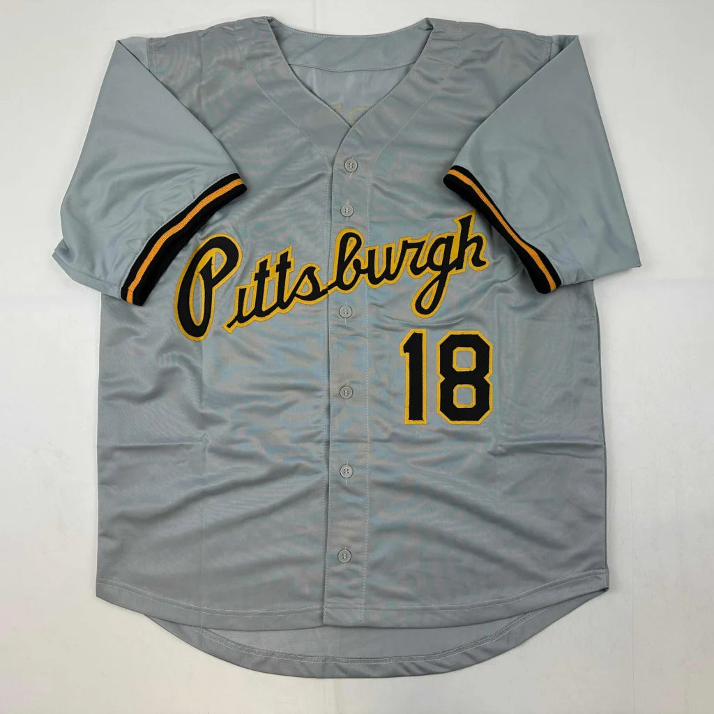 Gray professional sports jersey with Pittsburgh and 18 in yellow and black lettering