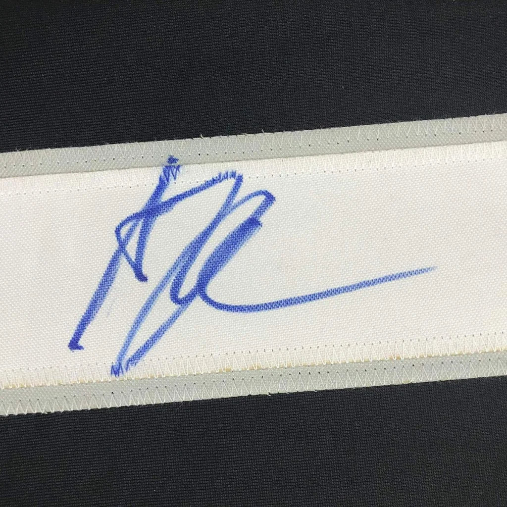 Blue ink autograph on white fabric of Anze Kopitar black hockey custom jersey