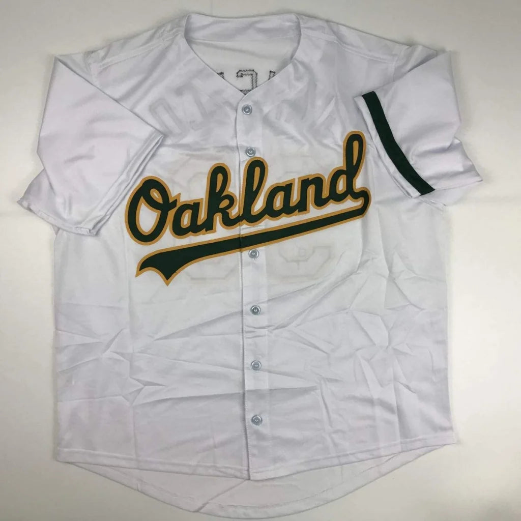 White short-sleeved Oakland custom jersey with green and gold lettering for professional sports fans