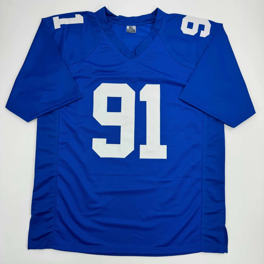 Blue football jersey with white 91 number from Authentic TUCK 91 Giants Jersey signed by professional sports legend