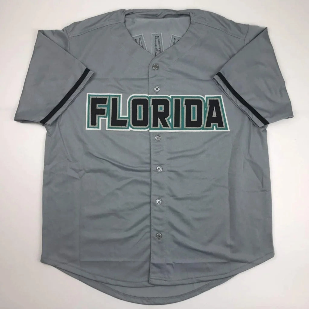 Gray florida custom baseball jersey with black and green lettering signed by Livan Hernandez 97 ws mvp professional sports league