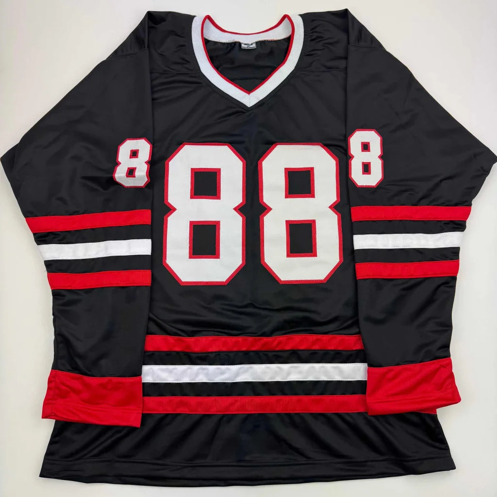 Black hockey jersey with red and white stripes and number 88 for professional sports league fans