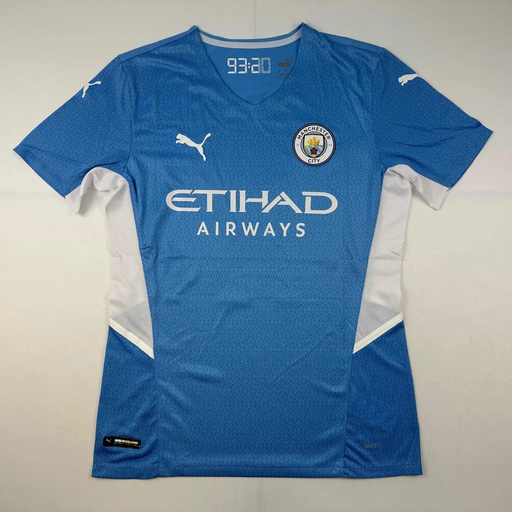 Light blue short-sleeved Manchester City jersey with white accents, third party authentication