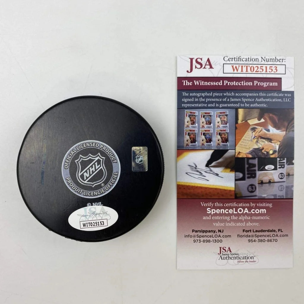 Black hockey puck with Silver NHL logo and third party authentication sticker