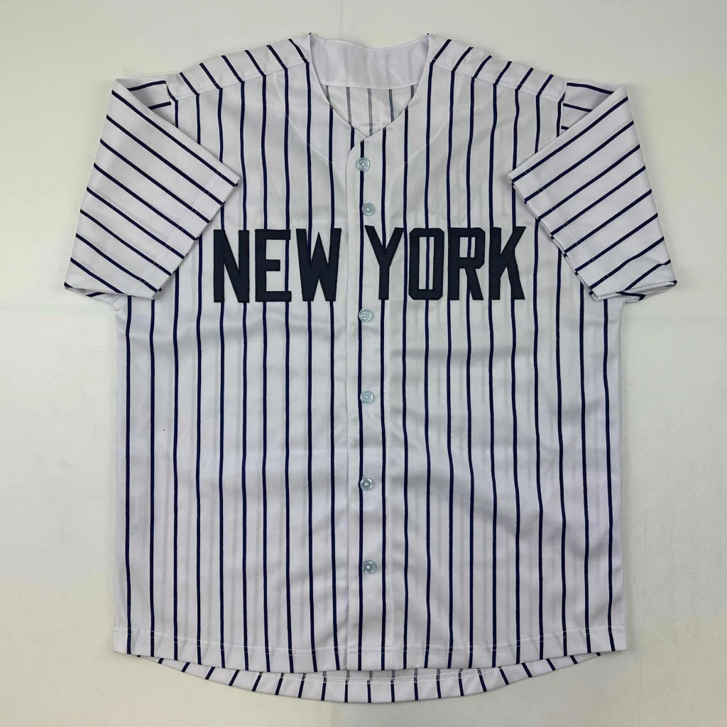 White baseball jersey with navy pinstripes and NEW YORK lettering from authentic professional sports league