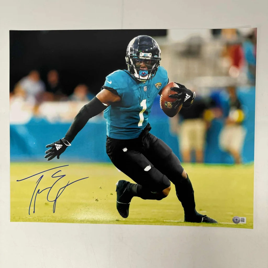 Autographed Jacksonville Jaguars player photo with COA holding football, perfect fan gift