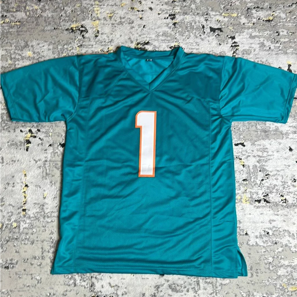 Teal Miami Dolphins jersey with autographed Tua Tagovailoa and number 1 in white with orange outline