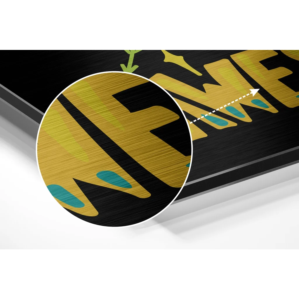 Black framed brushed aluminium dibond art with bold gold lettering and teal accents