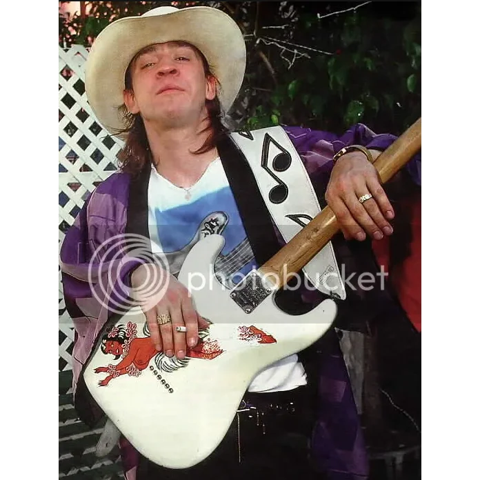 Axe Heaven Stevie Ray Vaughan mini white guitar with red black designs and stand