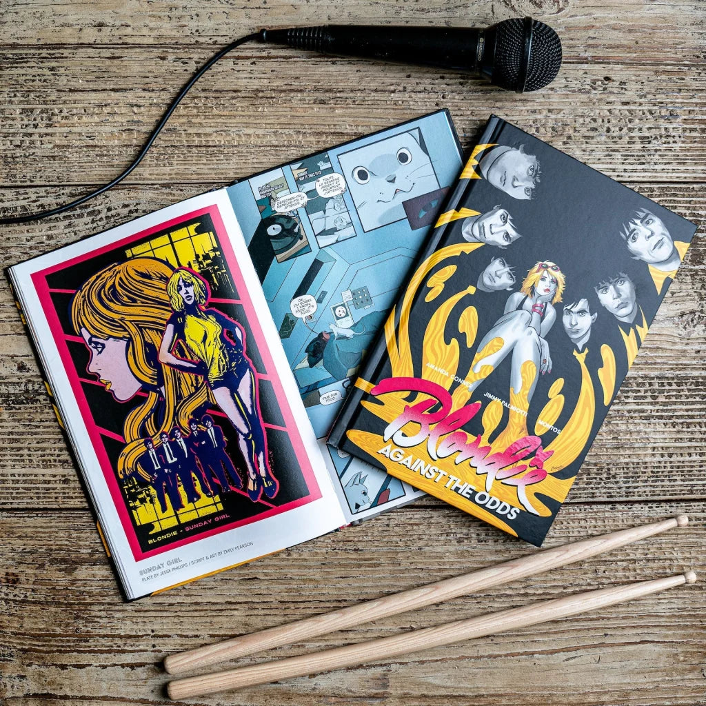 Sean Pryor Blondie Against The Odds graphic novel with music-themed comics, microphone, drumsticks