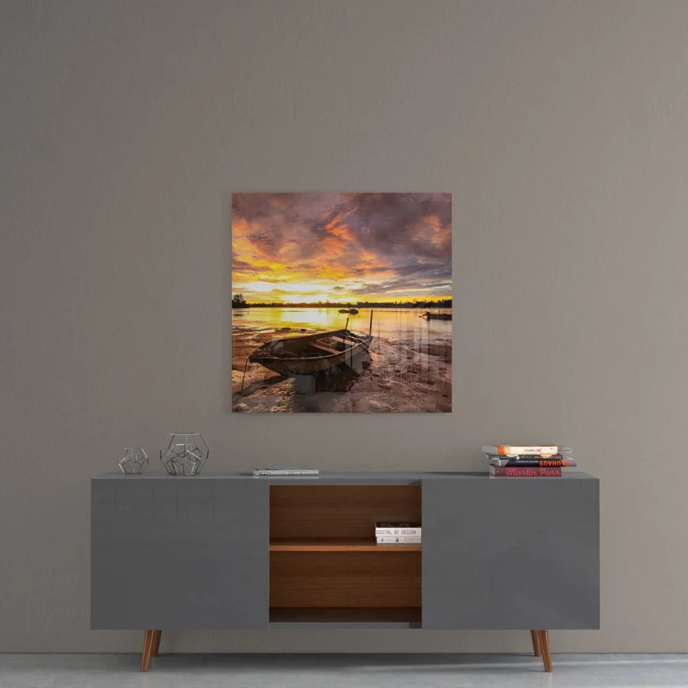 Sunset rowboat on muddy shore in tempered glass art
