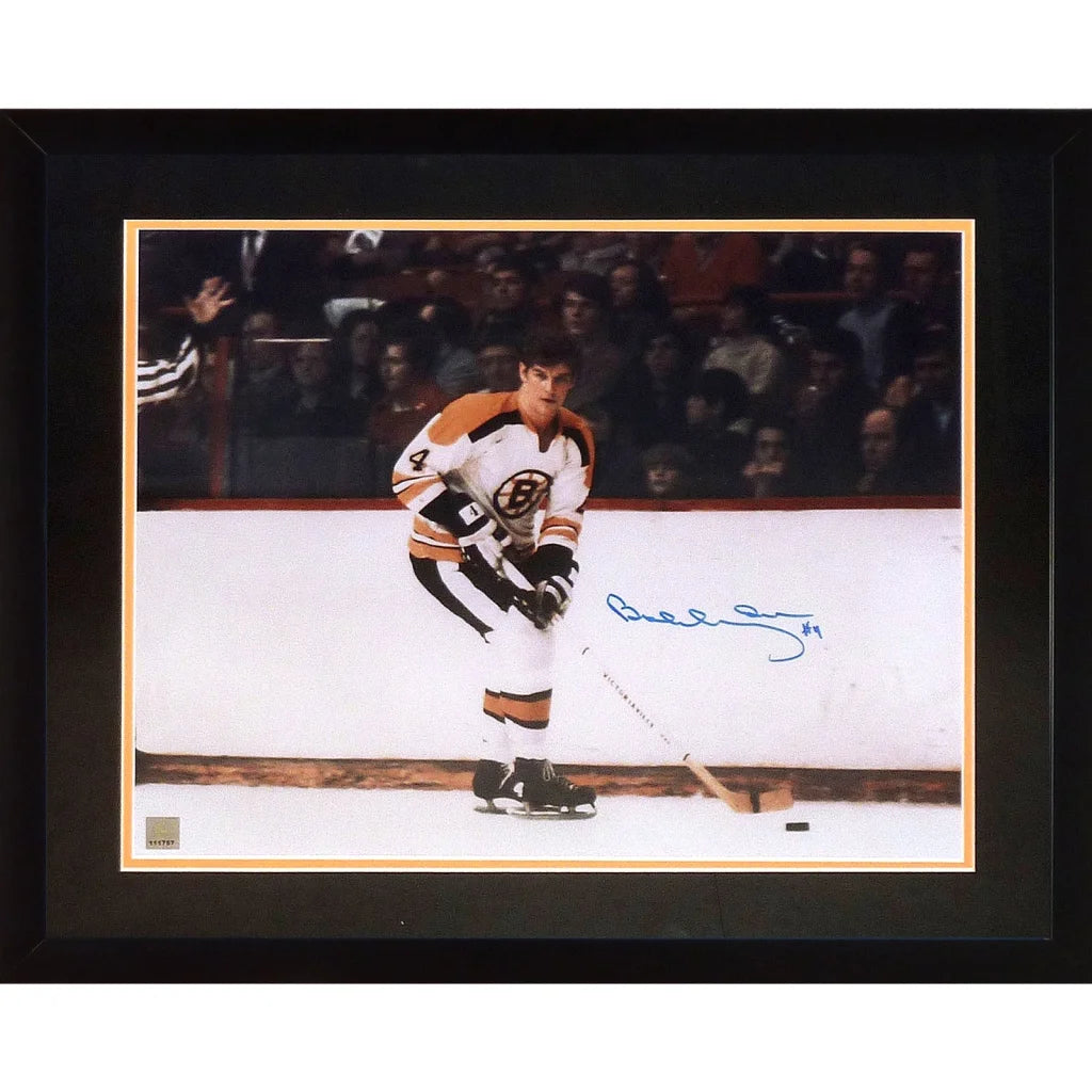 Framed 16x20 photo of bobby orr in white and orange boston bruins jersey holding stick on ice boston bruins collectible