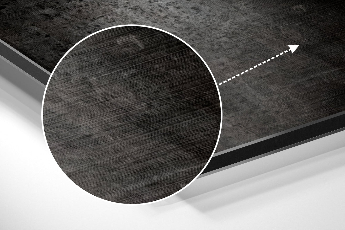 Angled close-up view of a circular brushed aluminum disc with directional arrow, showing metallic texture and grayscale tones.
