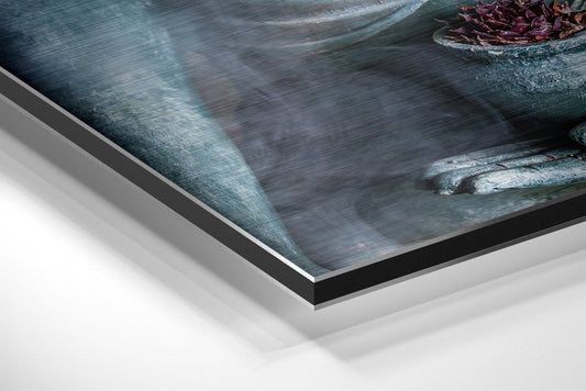 Close-up angled view of layered aluminum dibond print edges showing brushed metal trim and white backing material with serene Buddha artwork visible above.