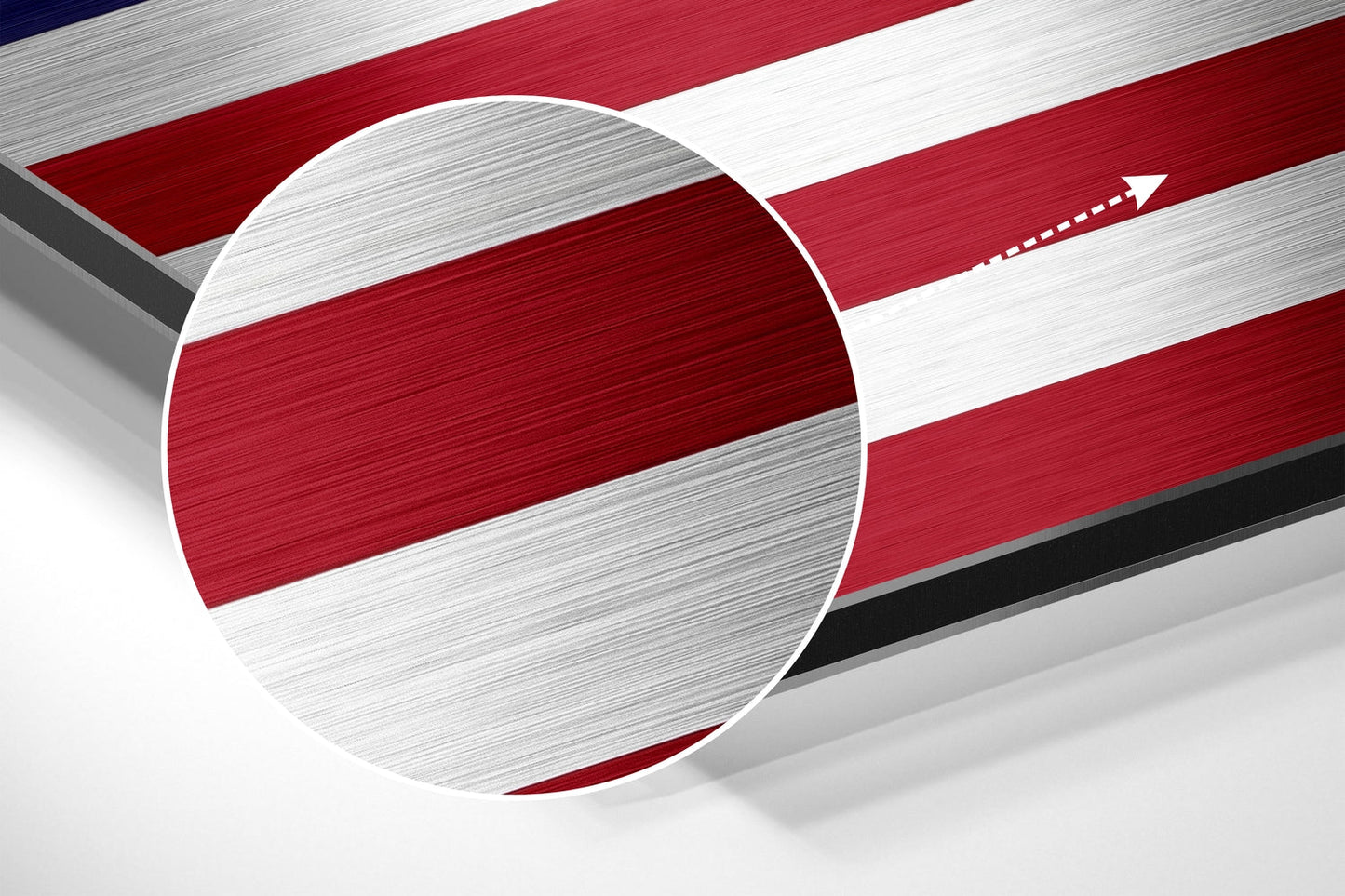 Close-up angled view of brushed aluminum American flag wall art showing red and white horizontal stripes with circular detail.