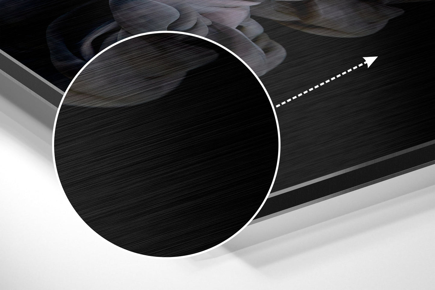 Close-up angled view of brushed aluminium Dibond wall art with circular white-bordered design and directional arrow detail on dark textured surface.