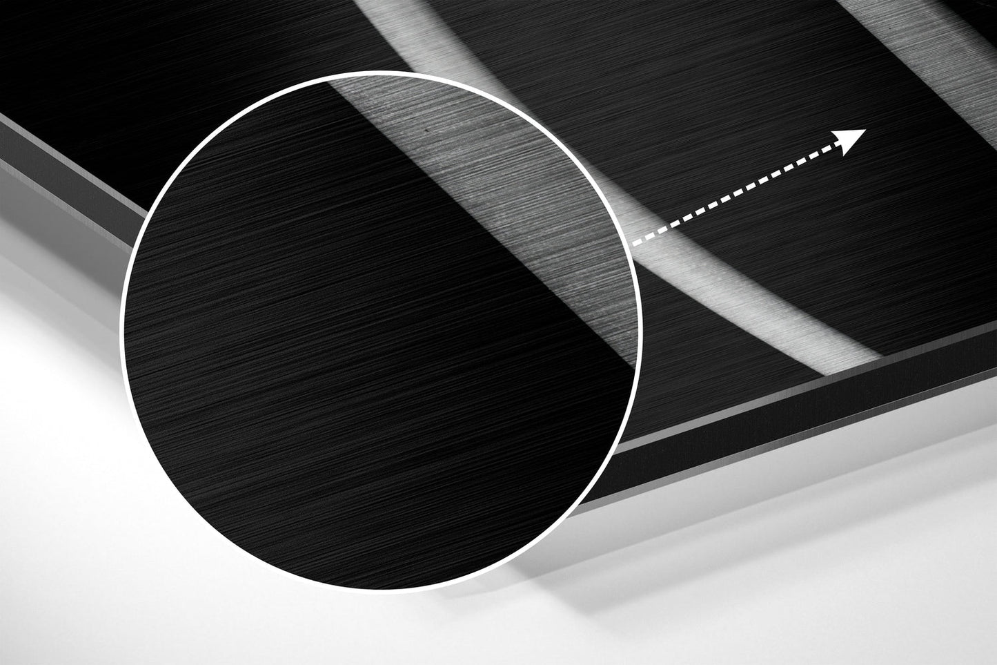 Abstract close-up of brushed aluminium wall art showing white circle outline and directional arrow on layered textured surfaces.