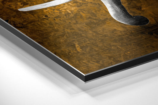 Close-up angled view of brushed aluminum dibond wall art with brown and gold elephant artwork and silver metal edges.