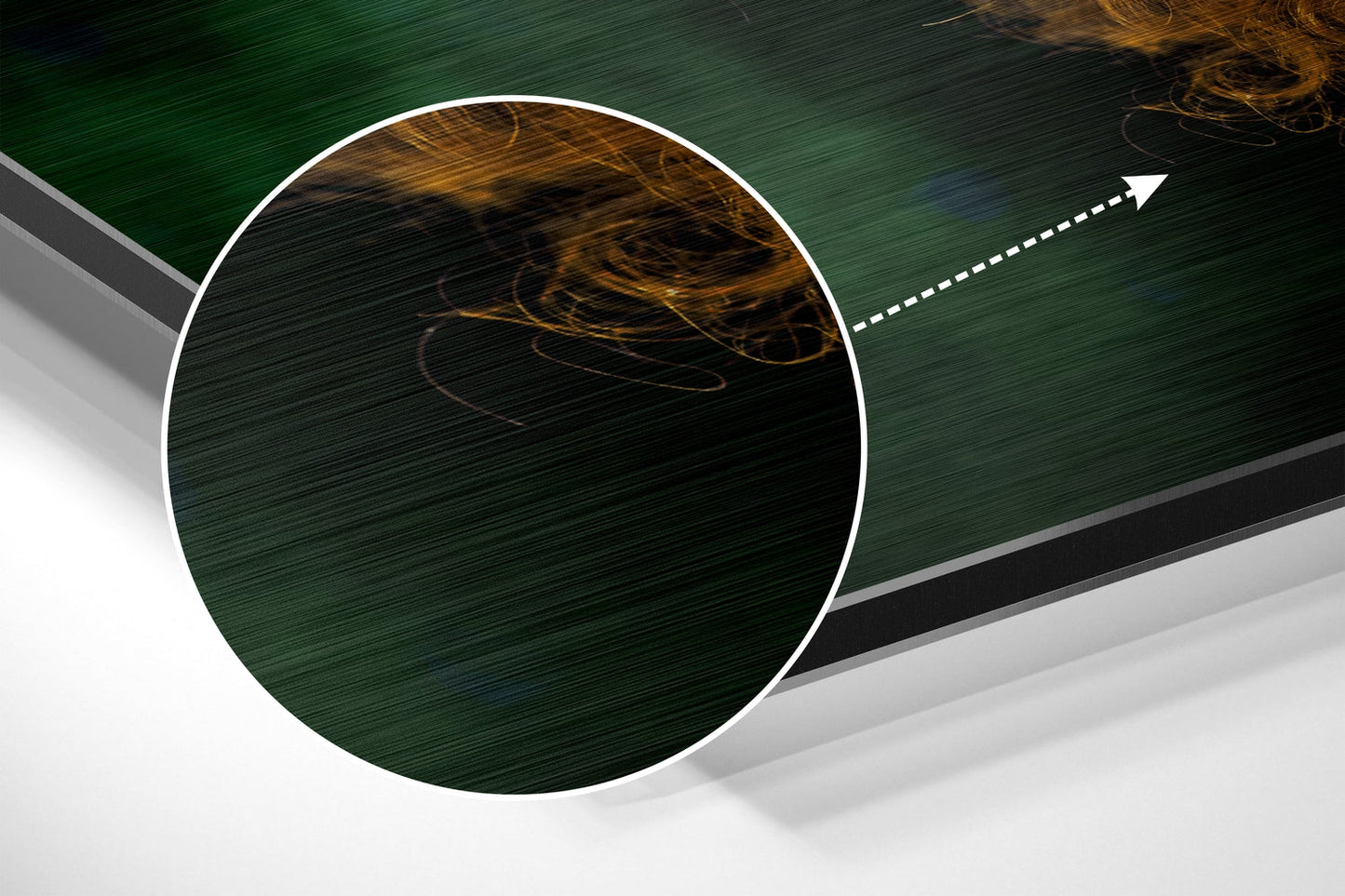 Angled product shot of brushed aluminium wall art with circular white-bordered frame containing dark green and gold swirled design, with directional arrow pointing upper right.