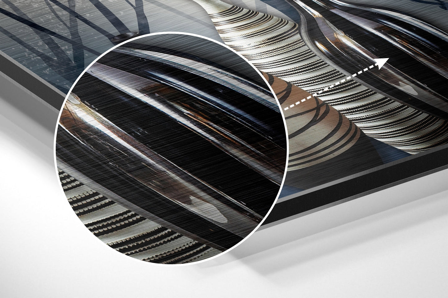 Close-up detail of brushed aluminium wall art showing layered metallic surfaces with diagonal striations and brown-toned accents in angled perspective.