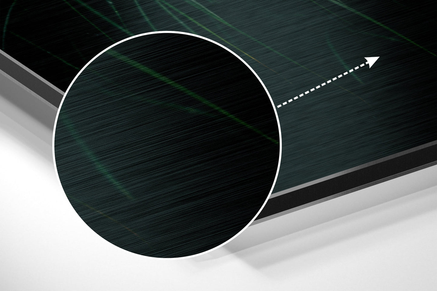 Close-up angled view of brushed aluminum wall art showing dark teal circular panel with white border and directional arrow against layered gray background.