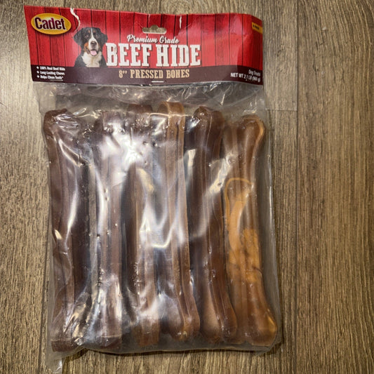 Cadet Premium Grade Beef Hide 8" Pressed Bones package displayed flat on wood flooring, showing brown rawhide chews visible through clear plastic.